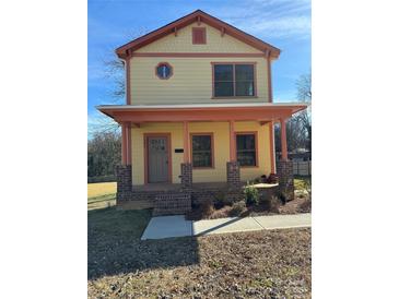 Charming two-story home with a welcoming front porch and colorful exterior at 523 W Front St, Statesville, NC 28677