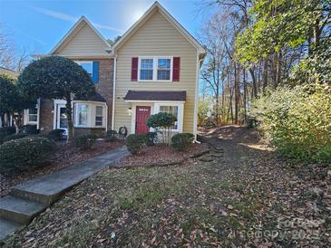 Two-story townhome with red door and landscaping at 8225 Pineville Matthews Rd # H, Charlotte, NC 28226