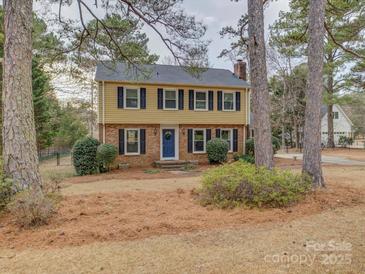 Two-story house with a yellow exterior, blue door, and landscaping at 860 Nightingale Rd, Rock Hill, SC 29732