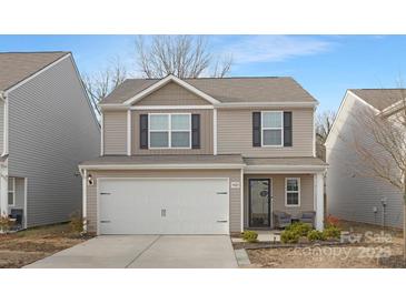 Two-story house with neutral siding, white garage door, and landscaping at 9025 Creedmore Hills Dr, Charlotte, NC 28214