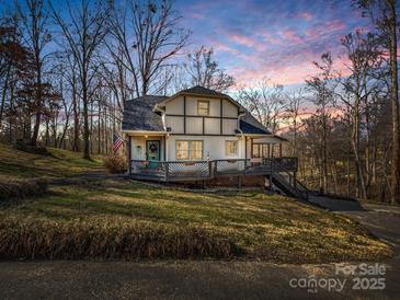 Charming two-story home with a welcoming front porch, American flag and beautiful landscaping at 108 Three Oaks Ln, Kings Mountain, NC 28086