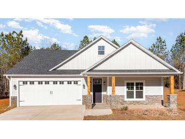 Charming single-story home with stone accents, a two-car garage, and a covered front porch at 1135 Rudder Cir, Salisbury, NC 28146