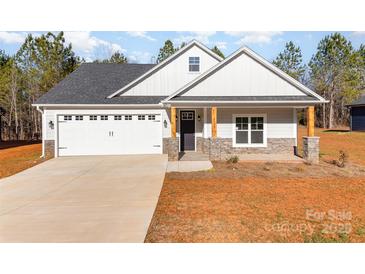 Craftsman style home with gray siding, stone accents, and a two-car garage at 1135 Rudder Cir, Salisbury, NC 28146