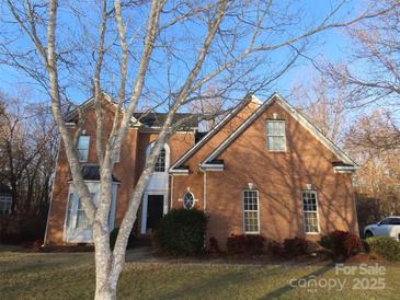 Brick house with a two-car garage and landscaped lawn at 130 Swift Creek Ln, Mooresville, NC 28115