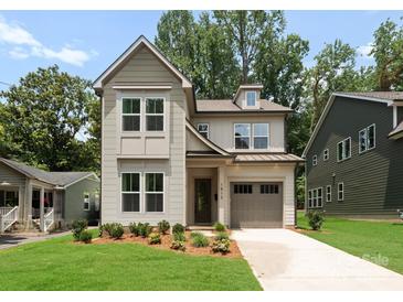 Charming two-story home boasts neutral paint, landscaped yard, and a one-car garage at 1912 St John St, Charlotte, NC 28216