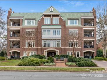 Brick building with green roof, featuring multiple entrances and landscaping at 2223 Croydon Rd # 103, Charlotte, NC 28207