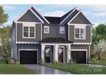 Two-story house with gray siding, black garage doors, and a landscaped lawn at 2234 Revolution Park Dr, Charlotte, NC 28208