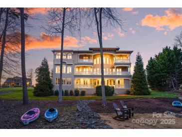 Expansive waterfront home boasts multiple balconies and a stunning sunset view, perfect for luxury living at 237 Wilson Lake Rd, Mooresville, NC 28117