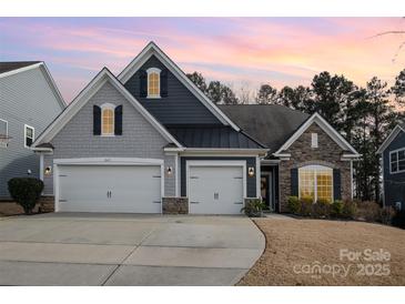 Two-story home with gray and dark siding, two-car garage, and landscaping at 245 Sweet Briar Dr, Fort Mill, SC 29707