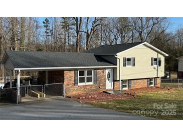 Brick ranch home with carport and landscaped yard at 3730 Sedgefield Dr, Conover, NC 28613