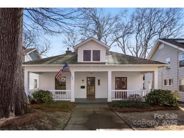 Charming home with a cozy front porch and American flag at 413 W 5Th Ave, Gastonia, NC 28052