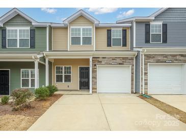 Two-story townhome with attached garage and neutral color scheme at 6340 Revolutionary Trl, Charlotte, NC 28217