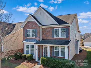 Brick two-story house with gray trim, landscaping, and a covered porch at 1010 Craven St, Indian Trail, NC 28079