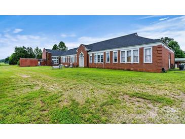 Brick building with large windows and a spacious yard at 1318 Ostwalt Amity Rd, Cleveland, NC 27013