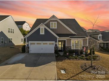 Charming two-story home with a well-manicured lawn and an attached two-car garage at 16812 Lookout Landing Ln, Charlotte, NC 28278