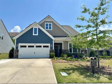 Charming two-story home featuring a spacious garage, beautiful landscaping and Craftsman-style architecture at 16812 Lookout Landing Ln, Charlotte, NC 28278