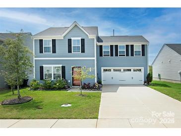 Two-story house with gray siding, two-car garage, and landscaped lawn at 171 Crownpiece St, Troutman, NC 28166