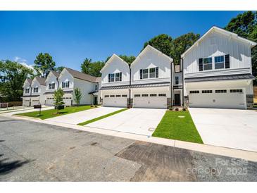 Row of new townhouses with white siding and attached garages at 19765 Feriba Pl, Cornelius, NC 28031