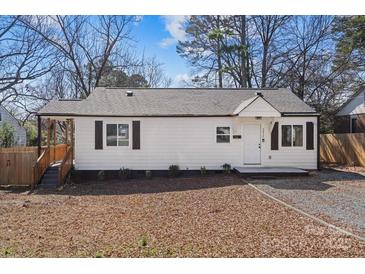 Charming single-story home with white siding, black shutters, and a well-maintained front yard at 3411 Rogers St, Charlotte, NC 28208