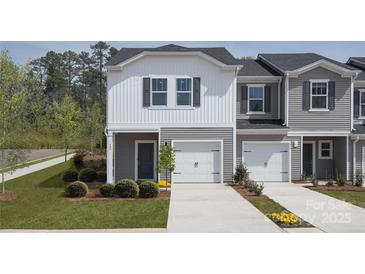 Modern two-story townhome with gray siding, white accents, and two-car garage at 3490 Backwater St, Concord, NC 28027