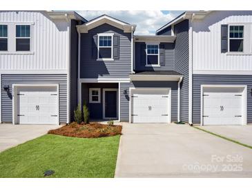 Charming townhouse with a well-manicured lawn, attached garage, and modern siding at 3500 Backwater St, Concord, NC 28027