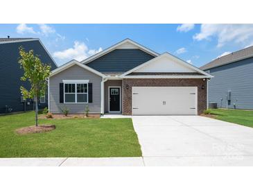 Charming single-story home showcasing a mix of siding, brick accents, and a convenient two-car garage at 4606 Harris Elliot Rd, Lincolnton, NC 28092