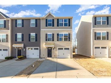 Inviting townhome showcasing two-story design, private garage and neutral color scheme at 828 Renee Ave, Fort Mill, SC 29715