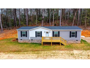 Gray and white mobile home with wood deck and landscaping at 118 River Ridge Ln, Hickory, NC 28601