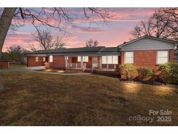 Brick ranch house with carport and porch at 200 11Th St, Spencer, NC 28159