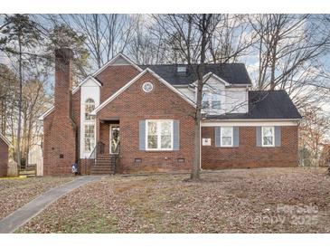 Two-story brick home with a charming front porch and walkway at 2000 Shannon Bridge Ln, Matthews, NC 28105