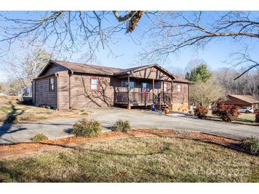 Brown house with a covered porch and landscaping at 3510 Flint Dr, Statesville, NC 28677
