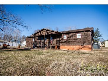 Ranch home with wood siding, covered porch, and a spacious yard at 3510 Flint Dr, Statesville, NC 28677