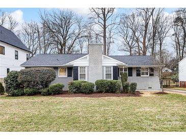 Gray brick ranch house with landscaped lawn and black shutters at 518 Hollis Rd, Charlotte, NC 28209