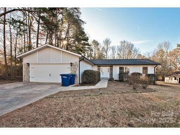 Ranch style home with attached garage, stone accents and landscaping at 8800 Crestwood Dr, Mount Pleasant, NC 28124