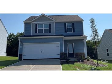 Two-story house with blue siding, white garage door, and landscaping at 1514 Doran Ter, Richburg, SC 29729