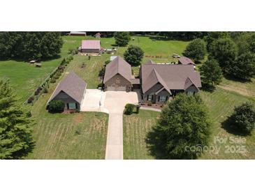 Aerial view of a house, detached garage, and large backyard at 1519 Triplett Rd, Cleveland, NC 27013