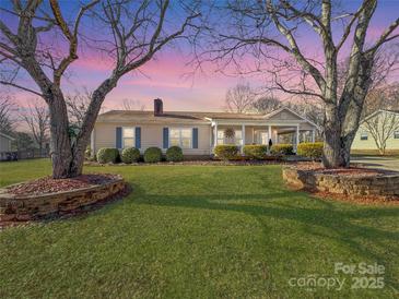 Ranch style home with landscaped lawn and stone accents at 2316 Woodfield Cir, Gastonia, NC 28056