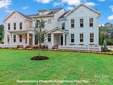 Three charming townhouses with white picket fences and lush green lawns at 270 Gilead Rd, Huntersville, NC 28078