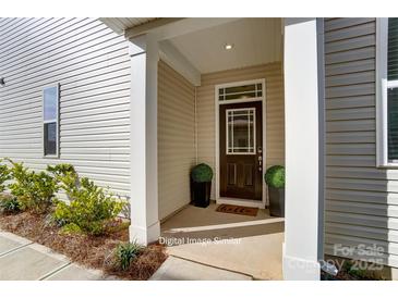 Inviting front entrance with a charming door and potted plants at 7220 Hodges Meadow Ln, Charlotte, NC 28213