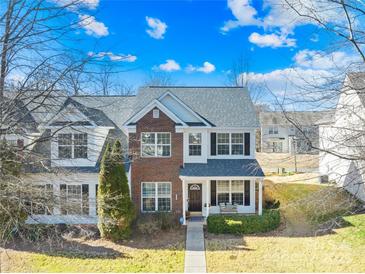 Two-story brick home with gray roof and front porch at 9813 Hanberry Blvd, Charlotte, NC 28213