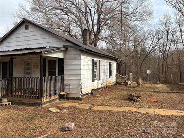 White house with porch and yard needs some TLC at 206 Barnyard Ln, Statesville, NC 28625
