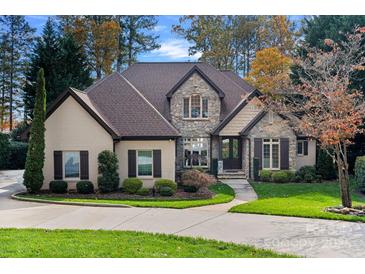 Inviting two-story home with stone accents and a landscaped lawn at 4628 Rustling Woods Dr, Denver, NC 28037