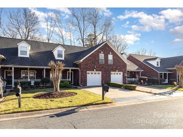 Brick front exterior of charming townhome with 2-car garage at 121 Quality Dr, Mount Holly, NC 28120