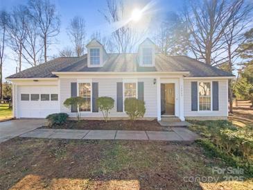 Charming one-story home with attached garage and well-manicured lawn at 13943 Dannemara Dr, Pineville, NC 28134