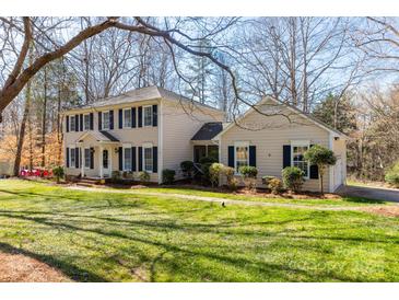 Charming two-story home with a well-manicured lawn and mature trees in a serene, residential neighborhood at 3153 Wimbledon Ln, Rock Hill, SC 29732