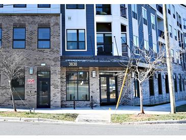 Modern apartment building with brick and blue accents at 3630 N Davidson St, Charlotte, NC 28205