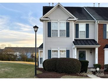 Two-story townhome with gray siding, dark trim, and landscaping at 4968 Sunburst Ln, Charlotte, NC 28213