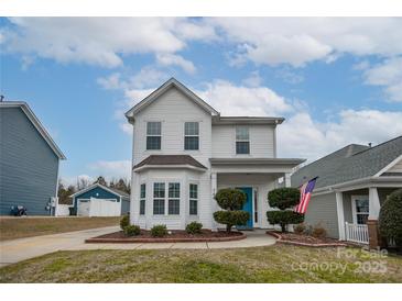 Two-story white house with landscaping and American flag at 748 Inwood Hill Dr, Gastonia, NC 28056