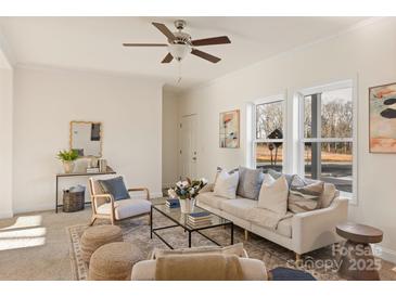 Bright living room featuring a comfortable sofa and neutral color palette at 7504 Surry Ln, Indian Trail, NC 28079