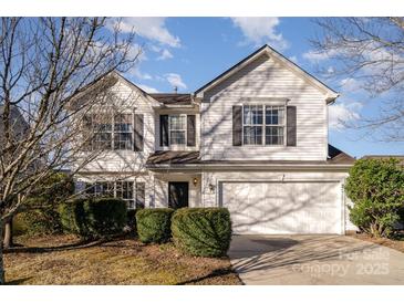 Two-story house with white siding, attached garage, and landscaping at 14311 Riding Hill Ave, Charlotte, NC 28213